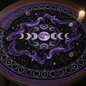 Celestial tarot reading cloth with purple moon phases and stars on black fabric